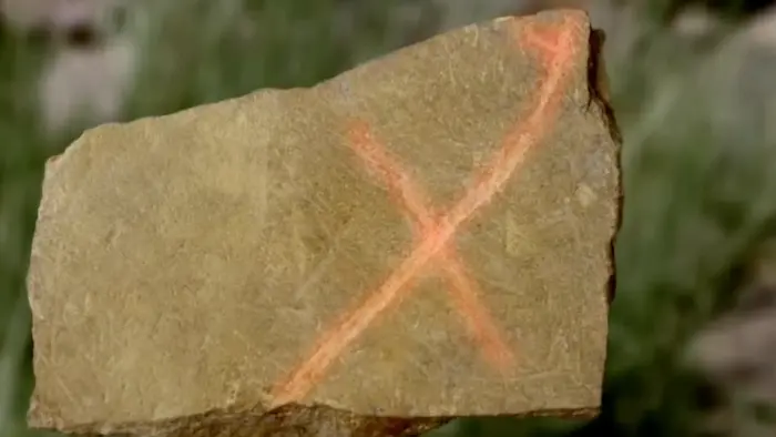 Flat Stone with Hooked X — modern carved_stone. found at The Swamp, Oak Island. Dated: Unknown