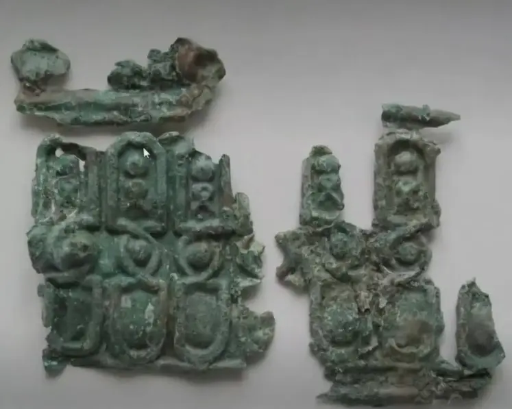 Folded copper/brass piece (decorated) — colonial artifact. found at Island General, Oak Island. Dated: Post-1500s; ~95% copper, 5% zinc (brass). Possibly late 1700s.