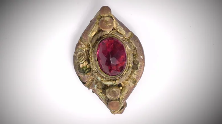 Gold-plated brooch (leaded glass gem) — medieval artifact. found at Island General, Oak Island. Dated: 14th century or earlier (threading technique)