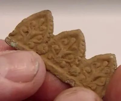 Metal bits with fleur-de-lis design — Oak Island artifact