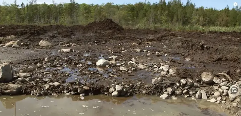 Paved area / stone wharf — medieval structure. found at The Swamp, Oak Island. Dated: Radiocarbon: wood beneath dated to c. 1200 AD