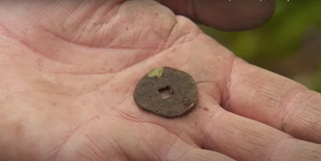 Submerged coin (possibly Chinese) — modern coin. found at Shoreline, Oak Island. Dated: Unknown
