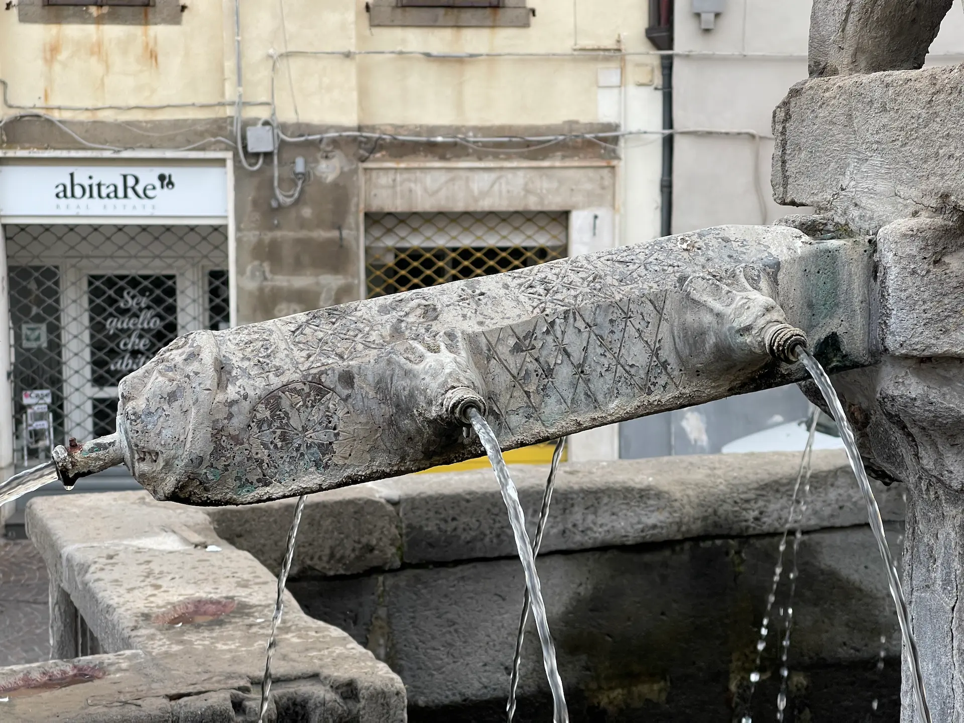 Detail of the Fontana Grande in Viterbo, featuring a 4 dot cross
